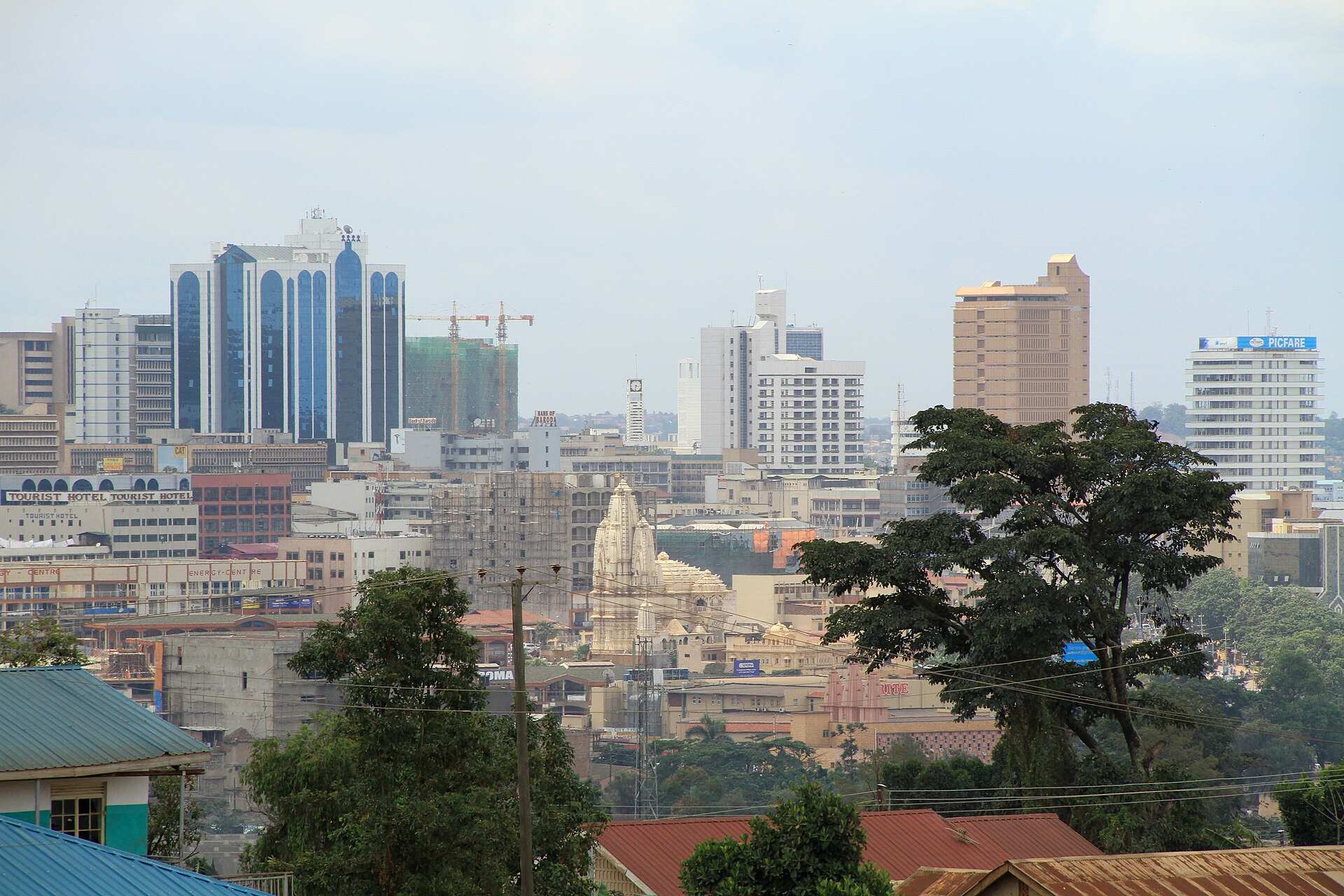 Central Kampala skyline seen across rooftops and trees
